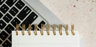 15 Best AI Content Tools in 2025: Scale Quality & E-E-A-T Notepad on a laptop for AI-assisted content writing