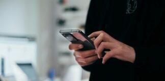 Google AI Mode in India: How It Works and What Site Owners Should Do Person holding a smartphone to search with Google AI Mode